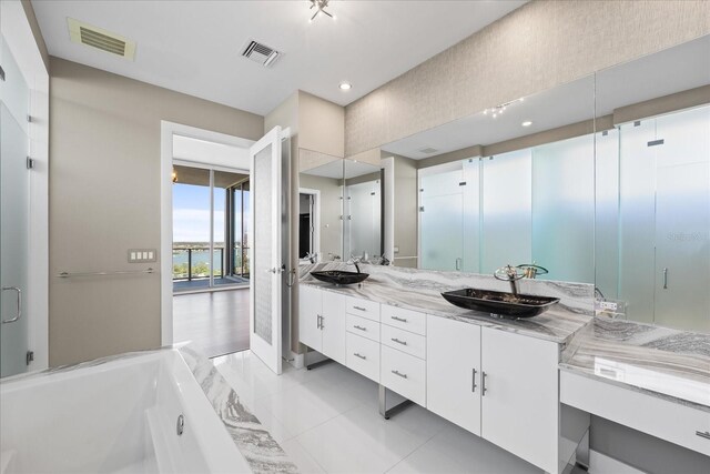 1155 N Gulfstream Ave Unit 1709, Sarasota, FL 34236 - full bathroom with a garden tub, double vanity, tile patterned floors, recessed lighting, and a stall shower