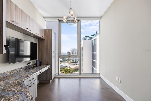 1155 N Gulfstream Ave Unit 1709, Sarasota, FL 34236 - kitchen with floor to ceiling windows, a chandelier, dark wood-style floors, hanging light fixtures, and dark stone counters