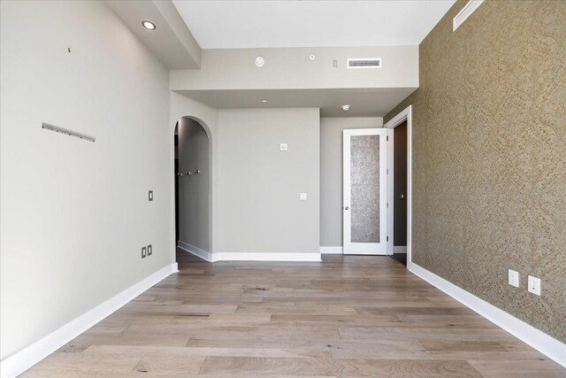 1155 N Gulfstream Ave Unit 1709, Sarasota, FL 34236 - spare room featuring arched walkways, light wood-style floors, and recessed lighting