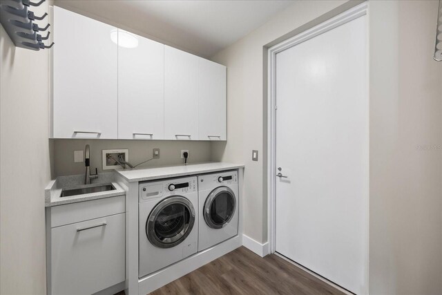 1155 N Gulfstream Ave Unit 1709, Sarasota, FL 34236 - washroom with washing machine and dryer, dark wood finished floors, and cabinet space