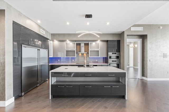 1155 N Gulfstream Ave Unit 1709, Sarasota, FL 34236 - kitchen featuring stainless steel appliances, wall chimney range hood, modern cabinets, and light countertops