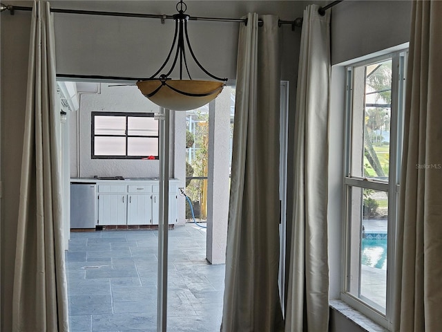 doorway to outside with stone finish floor