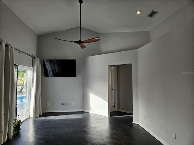 spare room with finished concrete flooring, ceiling fan, visible vents, and vaulted ceiling