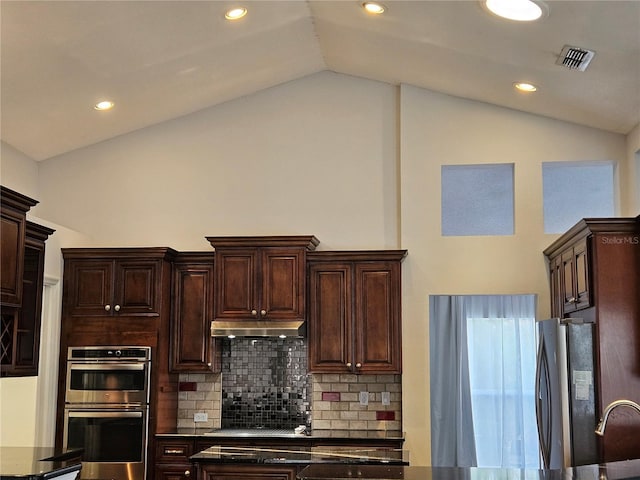 kitchen with stainless steel appliances, dark brown cabinets, visible vents, and tasteful backsplash