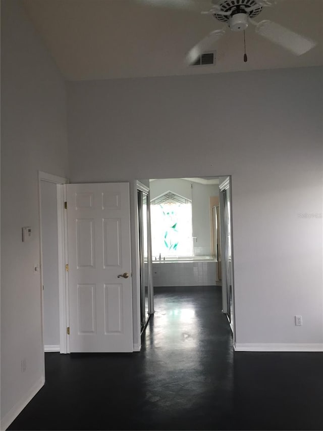 hallway featuring baseboards and visible vents