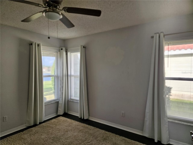 unfurnished room featuring ceiling fan, a textured ceiling, and baseboards