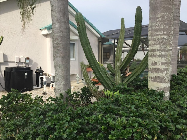 view of home's exterior featuring a lanai and stucco siding