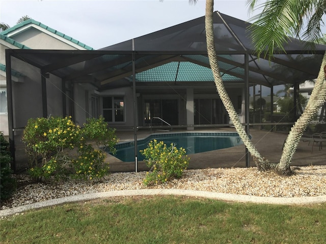 exterior space featuring glass enclosure and an outdoor pool