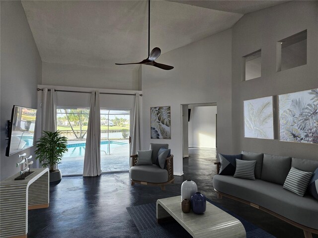 1211 Peridot Ln, Sun City Center, FL 33573 - living area featuring high vaulted ceiling, baseboards, a ceiling fan, and concrete floors