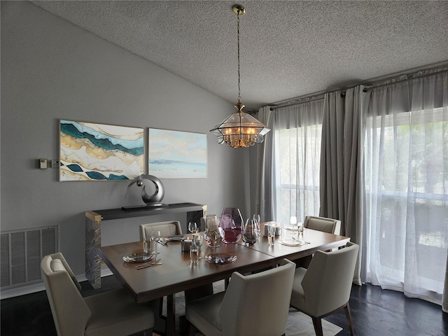 1211 Peridot Ln, Sun City Center, FL 33573 - dining room with visible vents, a textured ceiling, dark wood-style flooring, and an inviting chandelier