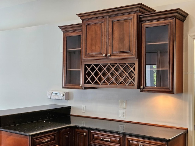 1211 Peridot Ln, Sun City Center, FL 33573 - kitchen featuring dark brown cabinets, dark countertops, and glass insert cabinets