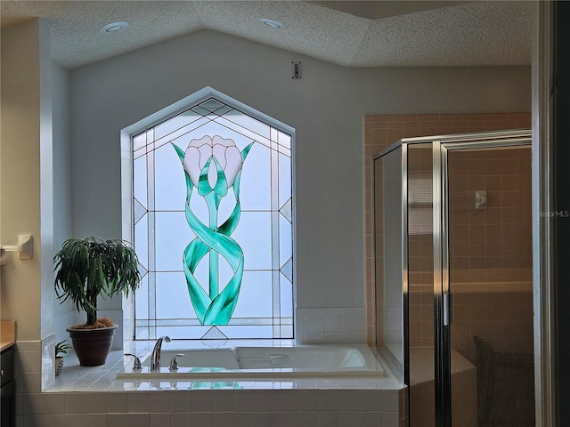 1211 Peridot Ln, Sun City Center, FL 33573 - bathroom featuring a textured ceiling, lofted ceiling, a shower stall, and a garden tub
