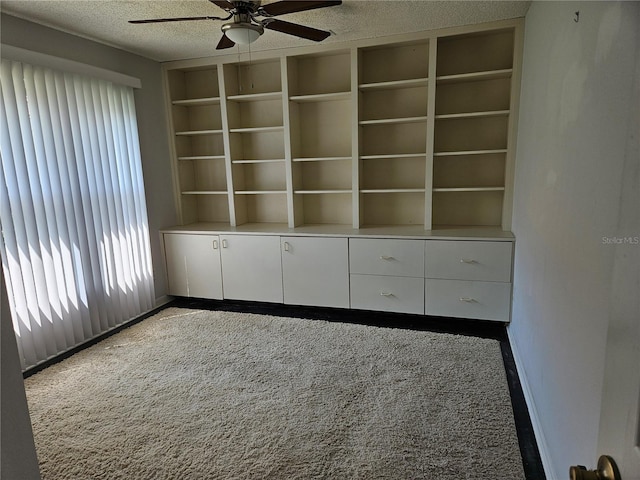 1211 Peridot Ln, Sun City Center, FL 33573 - unfurnished room with baseboards, a ceiling fan, a textured ceiling, and carpet flooring
