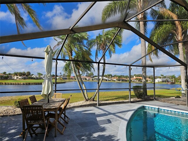 1211 Peridot Ln, Sun City Center, FL 33573 - outdoor pool featuring a yard, a patio, a water view, and a lanai