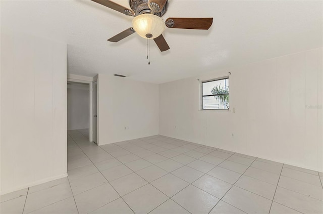 spare room featuring ceiling fan and light tile patterned floors