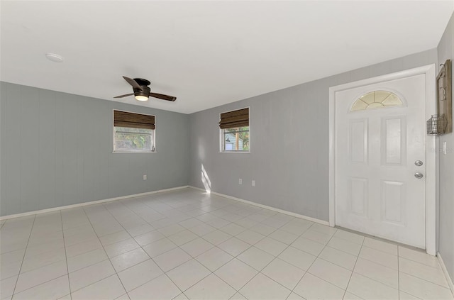 tiled empty room with ceiling fan