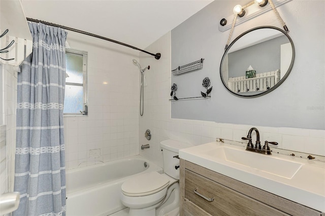 full bathroom with tile walls, vanity, shower / tub combo, and toilet