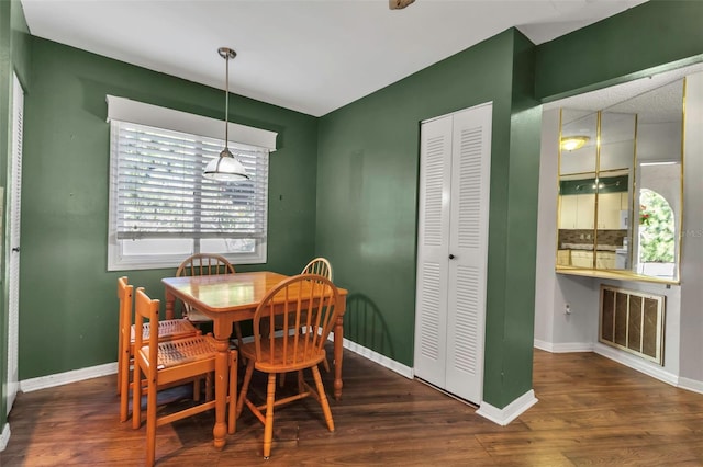 dining space with dark hardwood / wood-style flooring