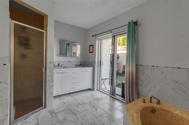 bathroom with shower with separate bathtub, tile walls, and vanity