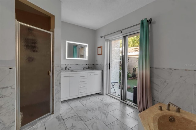 bathroom featuring tile walls, a textured ceiling, and walk in shower