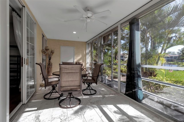 sunroom featuring ceiling fan