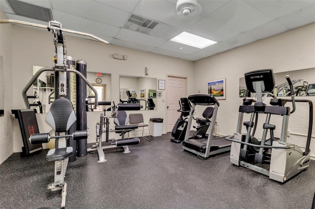 workout area with a paneled ceiling