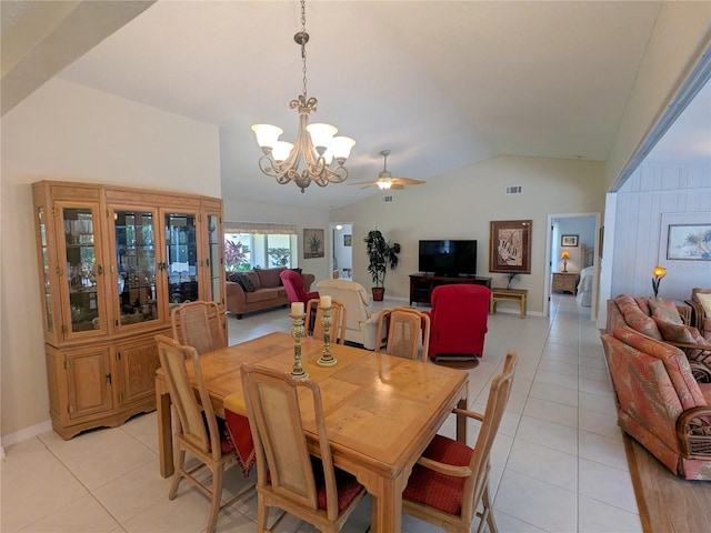 tiled dining space featuring ceiling fan with notable chandelier and vaulted ceiling