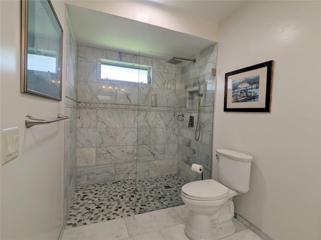 bathroom featuring toilet and tiled shower