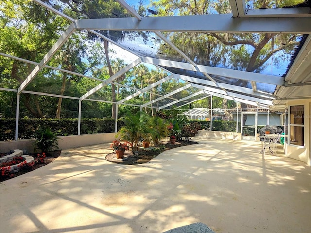 view of patio with glass enclosure