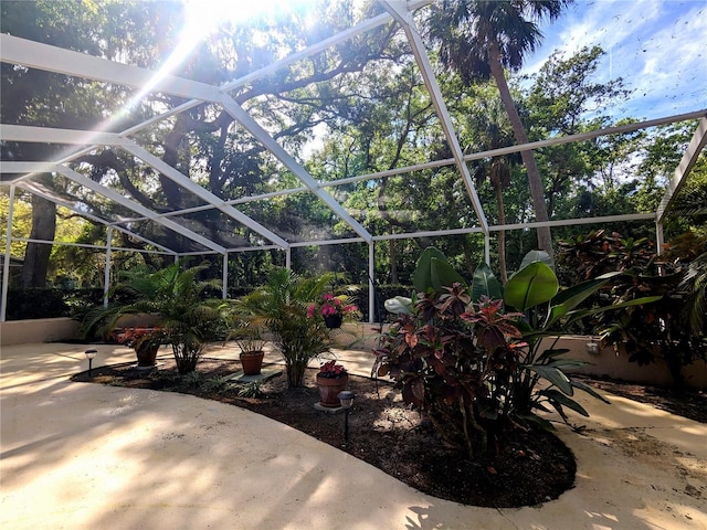 view of patio featuring glass enclosure