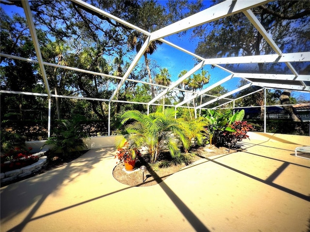 view of patio with glass enclosure