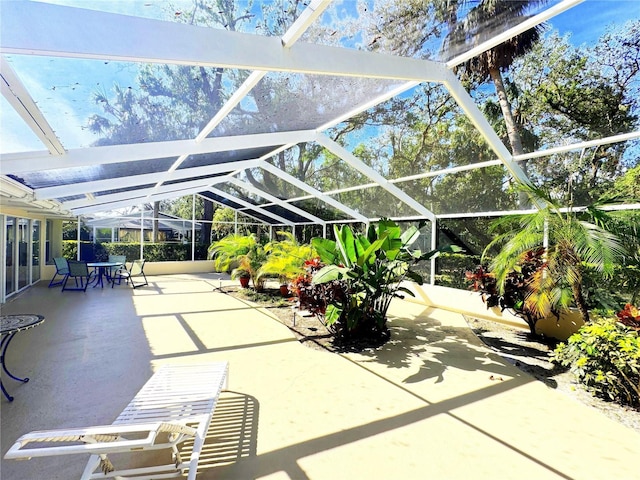 view of patio featuring glass enclosure