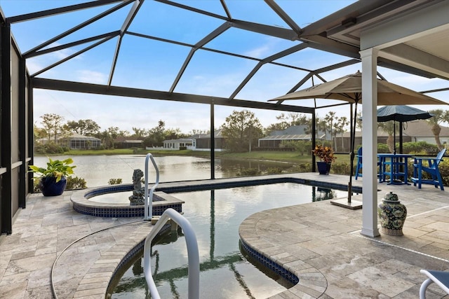 view of pool with an in ground hot tub, a water view, glass enclosure, and a patio area