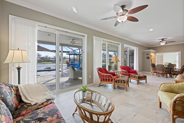 living room with ornamental molding, ceiling fan, and a water view