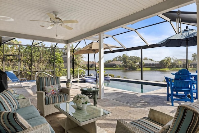 view of patio / terrace with a water view, ceiling fan, an outdoor hangout area, and glass enclosure