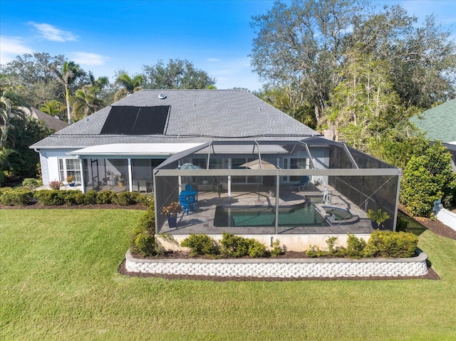 rear view of property with a yard, a lanai, a patio area, and solar panels