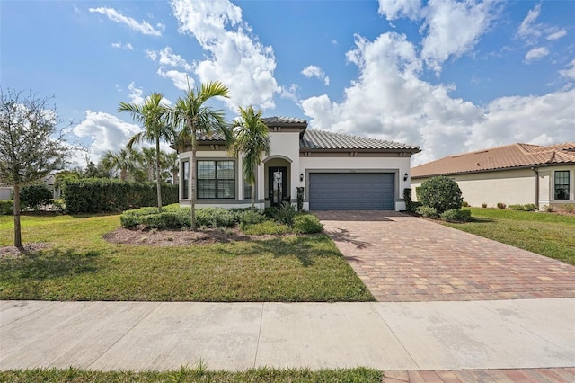 mediterranean / spanish-style home featuring a front yard and a garage