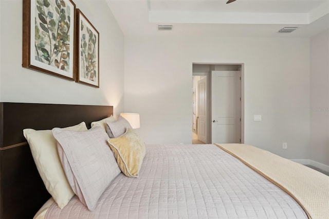 bedroom featuring a raised ceiling