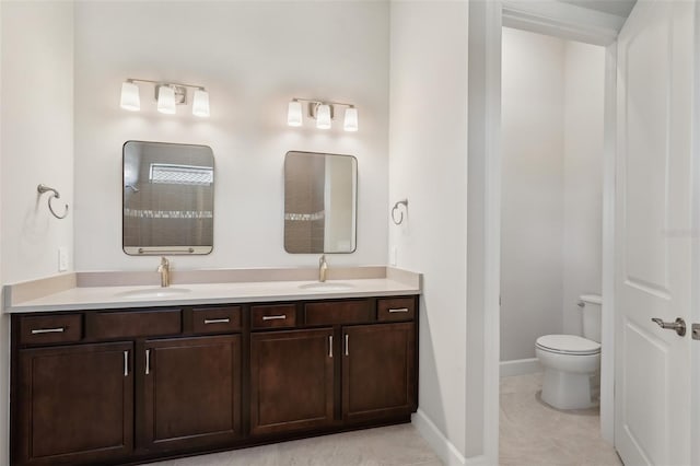 bathroom with vanity, tile patterned flooring, and toilet