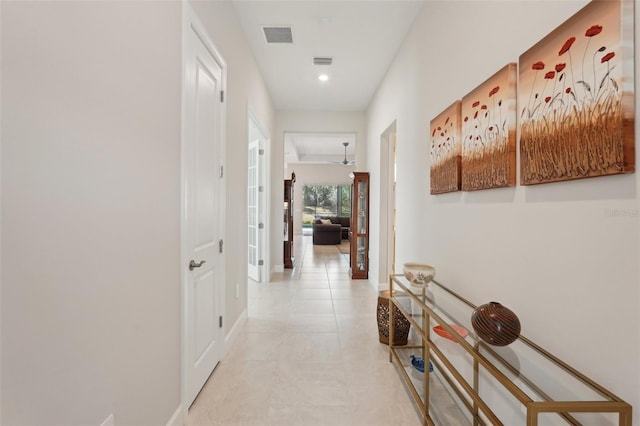 corridor featuring light tile patterned flooring