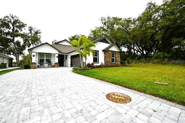 view of front of property featuring a garage and a front lawn