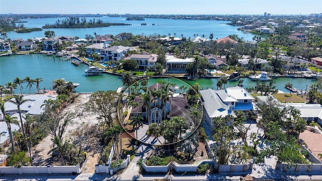 drone / aerial view featuring a water view and a residential view