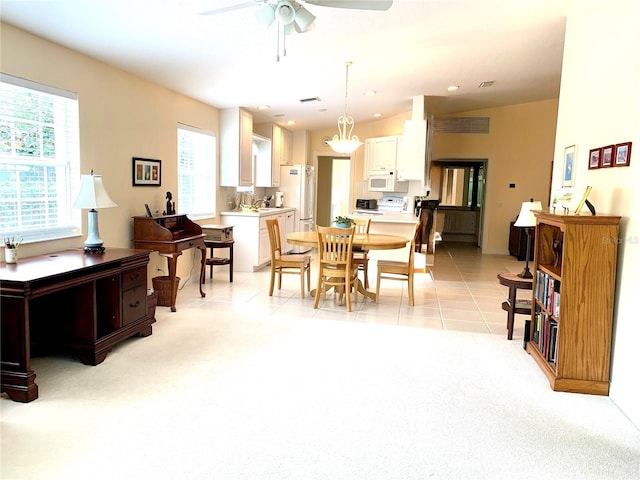 7649 Quinto Dr, Sarasota, FL 34238 - dining room featuring light carpet, a ceiling fan, and light tile patterned flooring