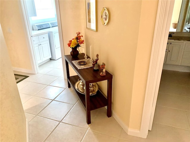 7649 Quinto Dr, Sarasota, FL 34238 - hall featuring independent washer and dryer and light tile patterned floors