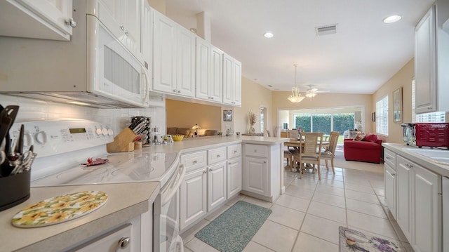 7649 Quinto Dr, Sarasota, FL 34238 - kitchen featuring visible vents, light countertops, white cabinetry, and white appliances