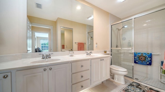 7649 Quinto Dr, Sarasota, FL 34238 - bathroom with visible vents, a sink, a stall shower, and double vanity