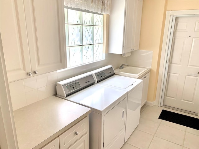 7649 Quinto Dr, Sarasota, FL 34238 - laundry room with independent washer and dryer, light tile patterned floors, a sink, and cabinet space