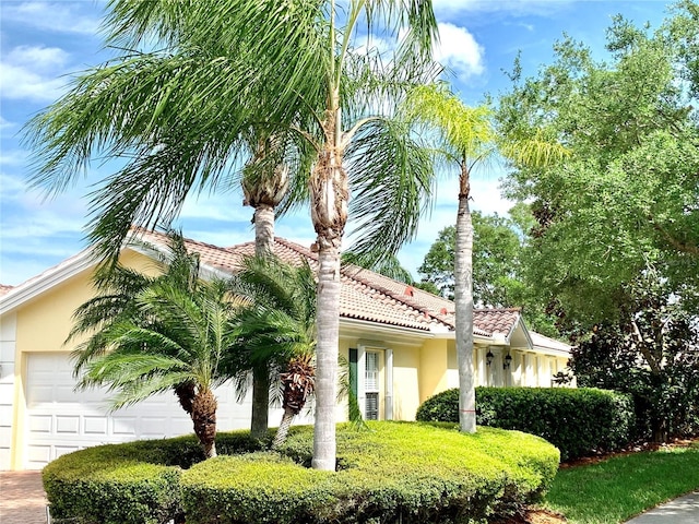 7649 Quinto Dr, Sarasota, FL 34238 - view of front of home featuring an attached garage, a tile roof, and stucco siding