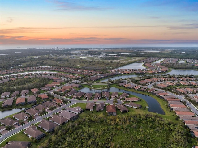 aerial view at dusk with a water view