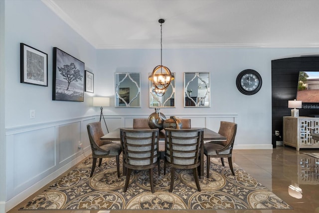 dining space featuring a notable chandelier and crown molding